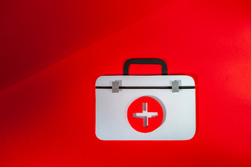 First aid kit on red background. World Health Day. Healthcare concept. Space for text. Soft focus....