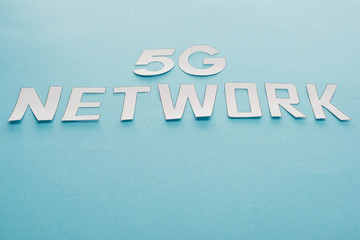 white 5g network lettering on blue background