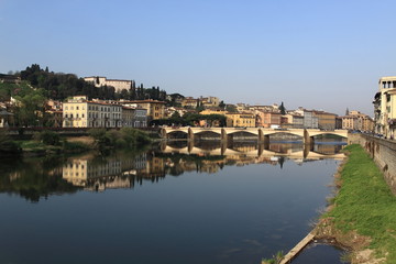 Fototapeta na wymiar View of Florence from the Arno River, palaces are reflected in the river. Morning