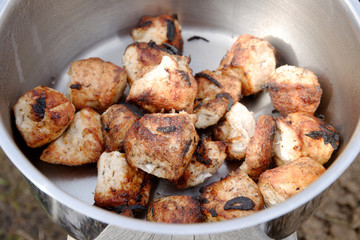 ready-made fried meat from the grill in a metal pan.