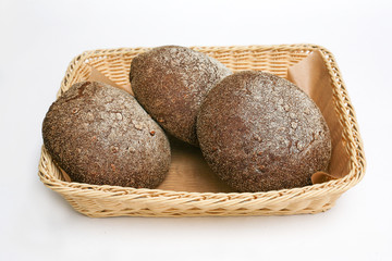 black bread with sunflower seeds in a basket white background
