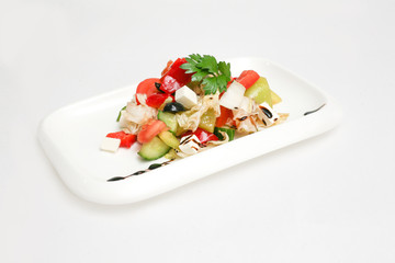 Greek salad on a plate white background