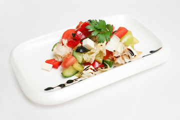 Greek salad on a plate white background