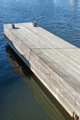 long wooden pier at river closeup