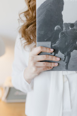 female hand holds a magazine