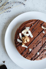 Chocolate raw vegan cake - healthy dessert made from coconut milk, butter, cashew, cacao, walnut. Top view