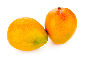 Fresh ripe mangoes close up isolated on white background