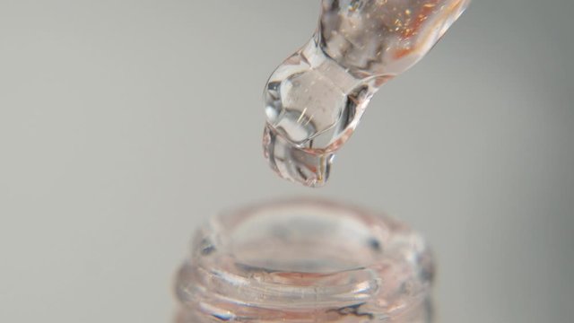 Drop of hydrating serum, oil, vitamin for face skin on white background. Skin care Essence, macro