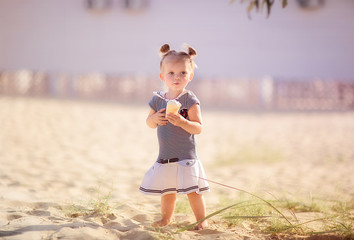 little seagirl with ice cream on the beach
