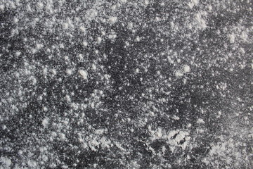dark gray Board dusted with flour or powdered sugar with a place to insert