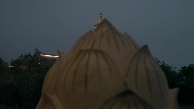 Rising Shot of Xa Loi stupa to Laughing Buddha statue at Bai Dinh Temple Spiritual and Culture Complex in Ninh Binh Vietnam, the largest spiritual tourist place in Vietnam