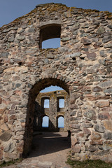 Fototapeta na wymiar Ruins of the Brahehus Sweden. Free entry. The entrance of the house. Lake Vattern can be seen through the windows.