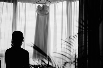young woman looking out window