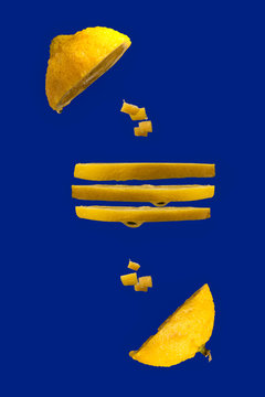 Whole lemon with stopped motion water drops on deep blue
