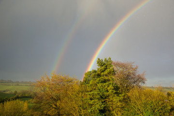Rainbow over trees in a summer storm near Shenington, Oxfordshire, UK