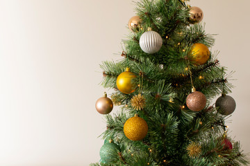 Beautiful Christmas tree with yellow and golden balls, with space for text
