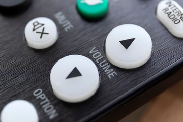 A close up portrait of the volume up and down buttons on a radio, television or surround sound...