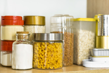 pasta, flour and cereals in glass jars on a shelf