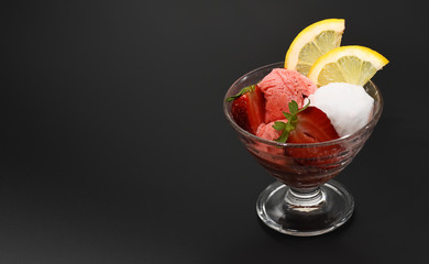 Glass with ice cream of strawberry and lemon