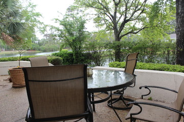 table and chairs with tress background 