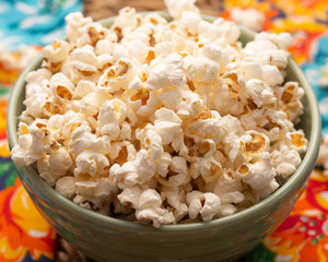 view of  big bowl  full of popcorn  on the straw table