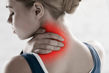 Athlete suffering from sports injury, feeling neck pain on white background