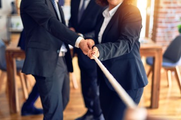 Business workers stretching rope at the office