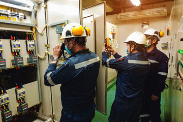 Electrician inspects the power control to find the abnormal condition of transformer by using thermo scanner. 
