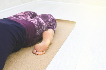 Young woman practicing yoga indoor.