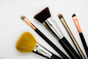 A top down view of a range of makeup brushes 