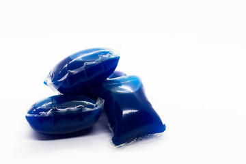 Bright vivid blue laundry capsules isolated against a white background