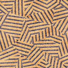 Embroidered seamless geometric pattern. Ornament for the carpet. Ethnic and tribal motifs. Vintage grunge texture. Colorful print of handmade. Orange, gray, black and white colors.