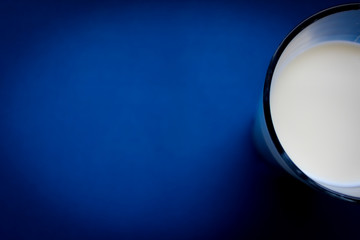 Glass of milk on a deep blue background