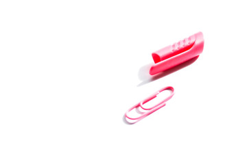 pink plastic cap and paper clip