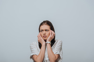 Stressed woman looking away isolated on grey