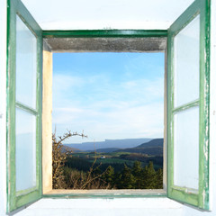 Old window with strong withe light open to a country landscape