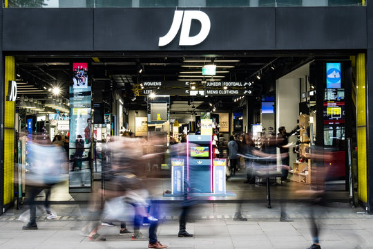 LONDON- JD Sports store with motion blurred shoppers- a casual British fashion and sports goods brand.