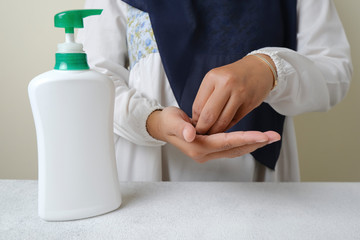 Washing hands by alcohol sanitizers or alcohol gel from pump bottle