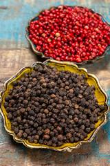 Bowl with dried black and red round peppers condiment