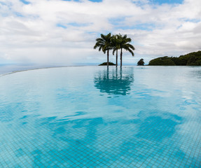 Fototapeta na wymiar Reflection Of Palm Trees On The Infinity Pool, Holualoa, Hawaii, USA