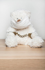 Fototapeta na wymiar image of toy wool bear mask handcuff table white background 