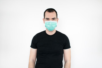 male man young black t-shirt stand white background wear mask on face.   protect yourself. save life coronavirus symbol