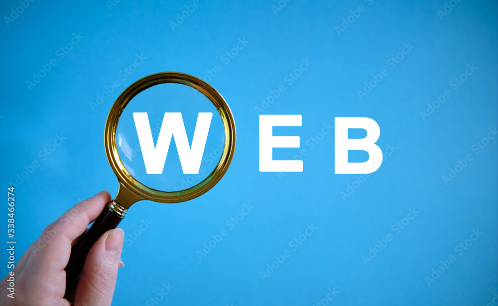Fototapete web - text with a magnifying glass on a blue background