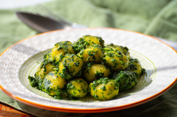 Tasty vegetarian food, italian potato gnocchi with green spinach filled with mozzarella cheese