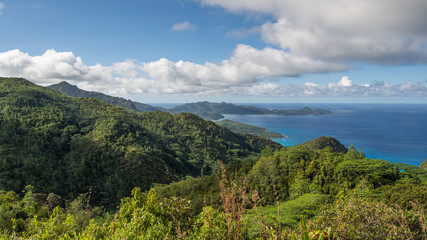 Fototapeta na wymiar A tropical Mountain Landscape was taken from the top of one of the mountains on the island of Mahe in Seychelles. This is from the north part of the island looking out into the Indian Ocean.