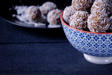 Coconut chocolate energy balls  closeup on dark background with copy space