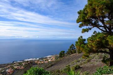 White high clouds, Atlantic ocean and black lava rocks