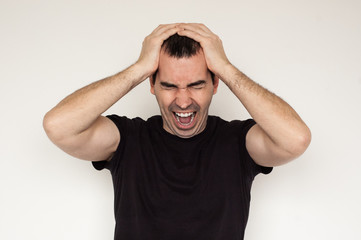 white male man migraine headache
black tshirt closeup hands white background painful