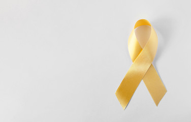 Gold symbolic ribbon - the problem of childhood cancer.
