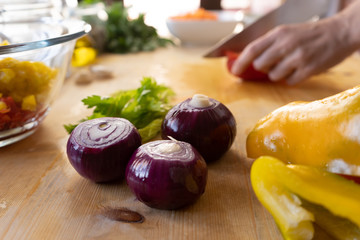 Moments of daily life in the Mediterranean cookery: low angle view of a young female cook cutting a...